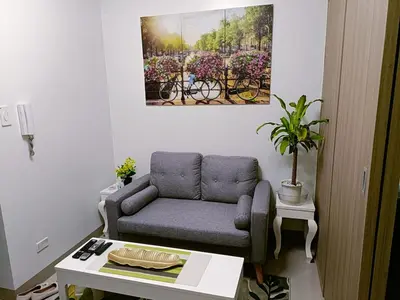 a living room with a couch and a table at Home away from Home in Manila