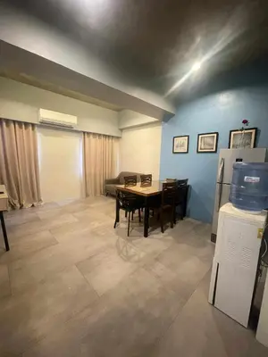 a dining room with a table and a couch at Spacious One Bedroom 20888 in Manila