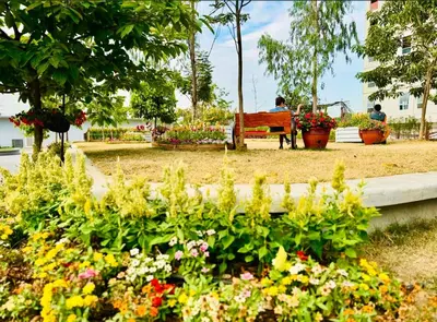 a park with flowers and a bench in the background at Pandora’s Nest in Manila