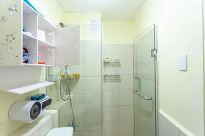 a bathroom with a shower and a toilet at Pandora’s Nest in Manila