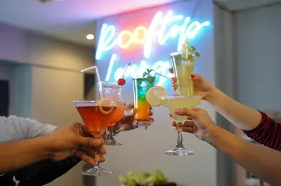 a group of people holding up their drinks at Arzo Hotel Premier in Manila