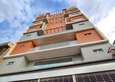 a building with orange doors on top of it at Arzo Hotel Premier in Manila