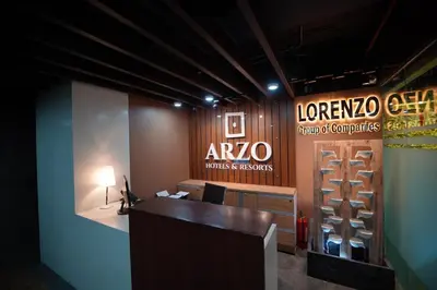 an office with a desk and a sign on the wall at Arzo Hotel Premier in Manila