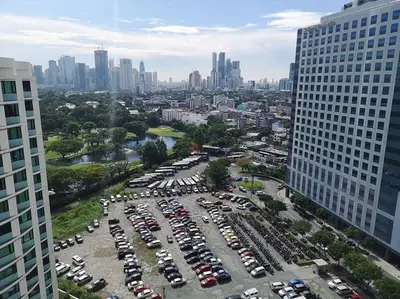 an aerial view of a parking lot in a city at A2J BGC Luxury 1BR Suite Near Burgos Circle & Mall in Manila