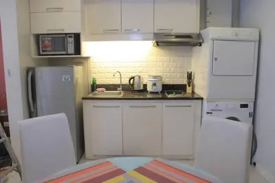 a small kitchen with a sink and a refrigerator at A2J BGC Luxury 1BR Suite Near Burgos Circle & Mall in Manila