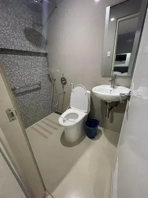 a small bathroom with a toilet and a sink at Hotel Sogo Edsa Cubao in Manila