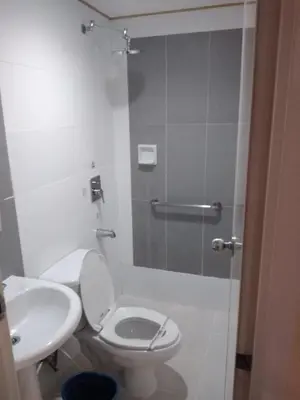 a bathroom with a shower and a toilet and a sink at Hotel Sogo Edsa Cubao in Manila