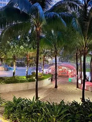 a group of palm trees in a park at Azure Urban Resort in Manila
