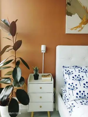 a bedroom with a bed and a plant on a nightstand at Azure Urban Resort in Manila