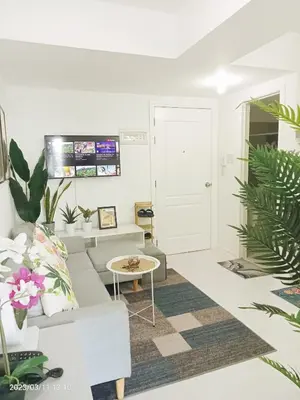 a living room with a couch and a table at Azure Urban Resort in Manila