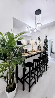 a kitchen with a island with chairs and a plant at Azure Urban Resort in Manila
