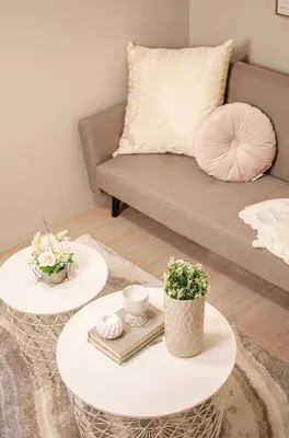 a living room with two tables and a couch at Cozy and Classy Studio Across Airport Terminal 3 in Manila