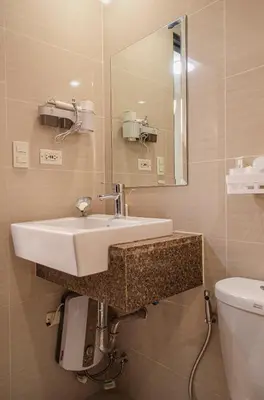 a bathroom with a sink and a toilet at Cozy and Classy Studio Across Airport Terminal 3 in Manila