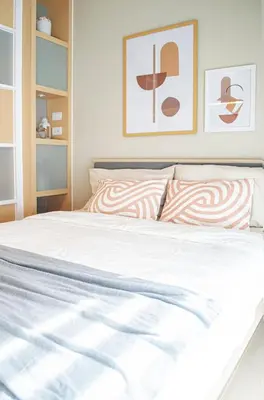 a bedroom with a white bed with two pillows at Cozy and Classy Studio Across Airport Terminal 3 in Manila