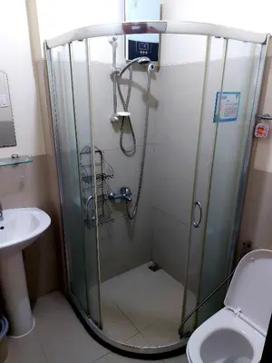 a shower in a bathroom with a toilet and a sink at Great Place at Beacon Tower Makati in Manila