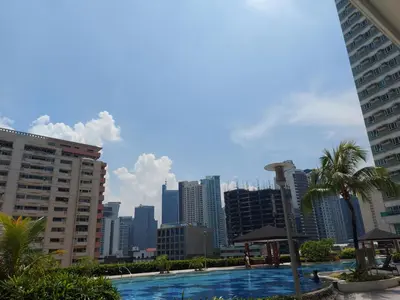a view of a city skyline with a swimming pool at Great Place at Beacon Tower Makati in Manila