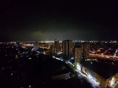 a view of a city at night with lights at Great Place at Beacon Tower Makati in Manila