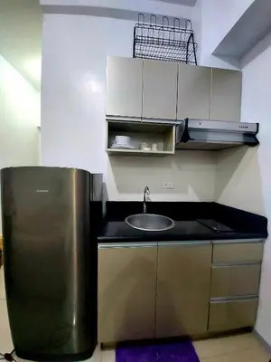 a kitchen with a sink and a counter top at Great Place at Beacon Tower Makati in Manila