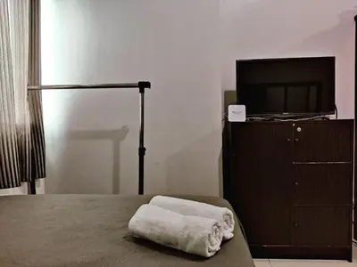 a bedroom with a bed and a tv on a dresser at Great Place at Beacon Tower Makati in Manila