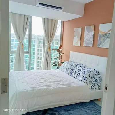 a bedroom with a white bed with a window at S-A-F-E Haven Resort Staycation in Manila