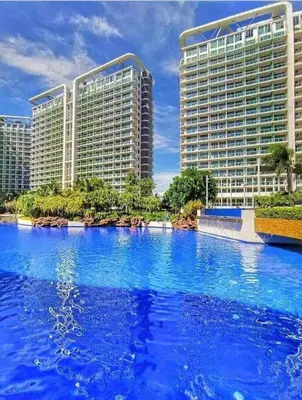 a large pool of blue water in front of buildings at S-A-F-E Haven Resort Staycation in Manila