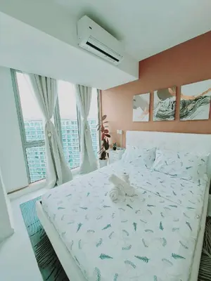 a white bed in a bedroom with a large window at S-A-F-E Haven Resort Staycation in Manila