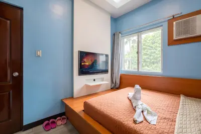 a bedroom with a bed with a stuffed animal on it at Casa Heradurra Uno/Dos in Manila