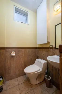 a bathroom with a toilet and a sink at Casa Heradurra Uno/Dos in Manila