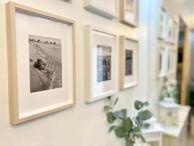 a row of pictures hanging on a wall at Will’s Place @ Shore2 Residences Mall of Asia in Manila