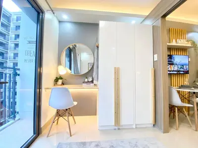 a dressing room with a mirror and a table at Will’s Place @ Shore2 Residences Mall of Asia in Manila