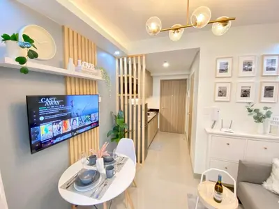 a living room with a tv on a wall at Will’s Place @ Shore2 Residences Mall of Asia in Manila