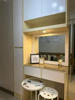 a room with a desk with two stools and a mirror at Mel and Rose Place in S Residences Tower 1 MOA in Manila