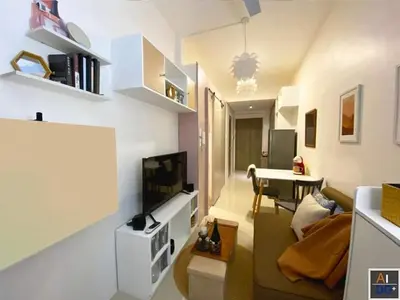 a small living room with a couch and a table at Fame Residences Tower-1 Unit 3207 in Mandaluyong 1 Br w Balcony City view in Manila