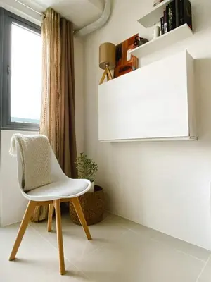 a white chair in a room with a window at Fame Residences Tower-1 Unit 3207 in Mandaluyong 1 Br w Balcony City view in Manila