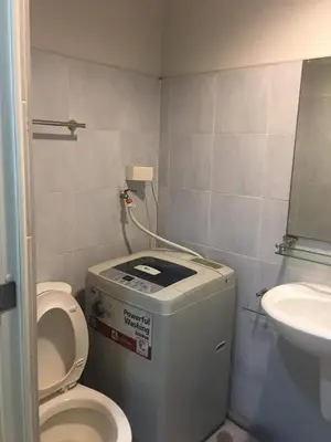 a small bathroom with a toilet and a sink at Sea Residences Prestige in Manila