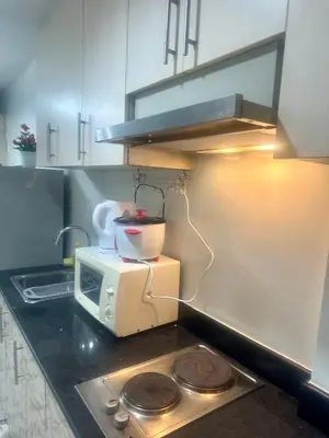 a kitchen with a mixer on top of a microwave at Sea Residences Prestige in Manila