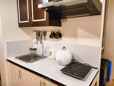 a kitchen with a sink and a counter top at Queen Bed Deluxe- Contemporary Style in Manila