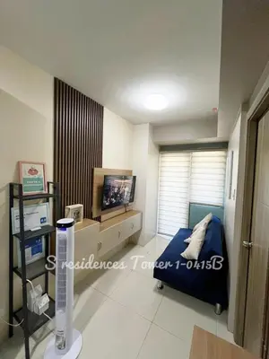 a bedroom with a bed and a tv in it at SMDC S Residences MiCasa, MOA area in Manila