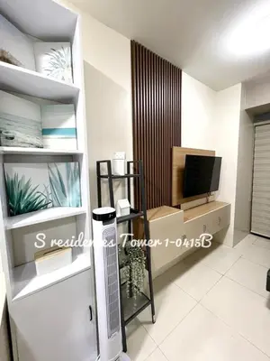 a living room with a television and a tv stand at SMDC S Residences MiCasa, MOA area in Manila