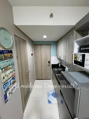 a kitchen with a refrigerator and a clock on the wall at SMDC S Residences MiCasa, MOA area in Manila