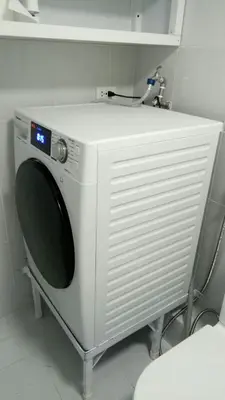 a white washing machine sitting in a bathroom at Lovely 2 BR Condo with FREE Secured Parking in Manila