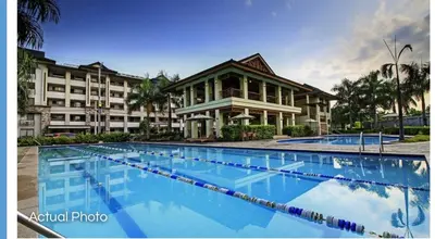 a large swimming pool in front of a building at Lovely 2 BR Condo with FREE Secured Parking in Manila