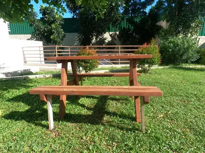 a wooden bench sitting in the grass at Choco Condotel- Anuva Prime 2 Cozy & Stylish Place in the Metro in Manila