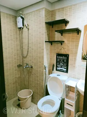 a bathroom with a toilet and a shower at Choco Condotel- Anuva Prime 2 Cozy & Stylish Place in the Metro in Manila