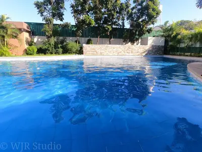 a swimming pool filled with blue water at Choco Condotel- Anuva Prime 2 Cozy & Stylish Place in the Metro in Manila