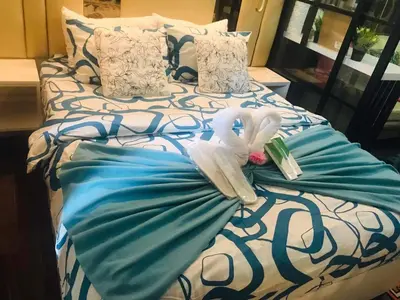 a bed with a towel and a swan on it at Luxurious Condotel at the heart of Makati in Manila
