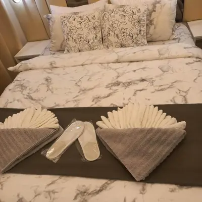 a pair of heels and a pair of shoes on a bed at Luxurious Condotel at the heart of Makati in Manila