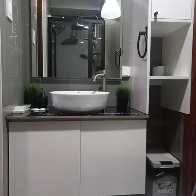 a bathroom with a white sink and a mirror at Luxurious Condotel at the heart of Makati in Manila