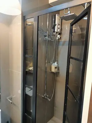 a shower with a glass door in a bathroom at Luxurious Condotel at the heart of Makati in Manila