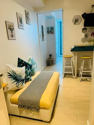 a bedroom with a bed and a bar in a room at Azure Urban Resort in Manila